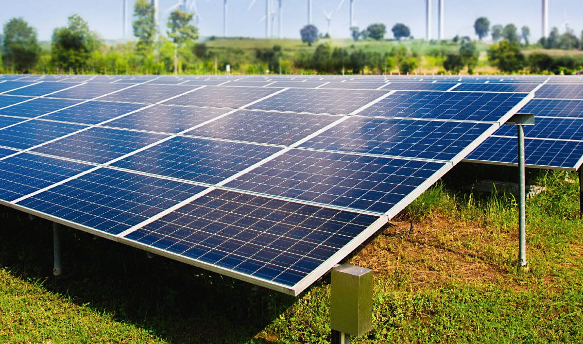 solar-panel-with-wind-turbines-against-mountains-sky