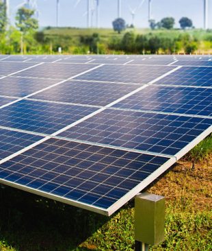 solar-panel-with-wind-turbines-against-mountains-sky